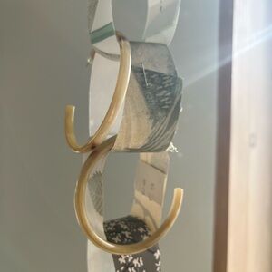 Large hoop earrings, bone or bison horn.